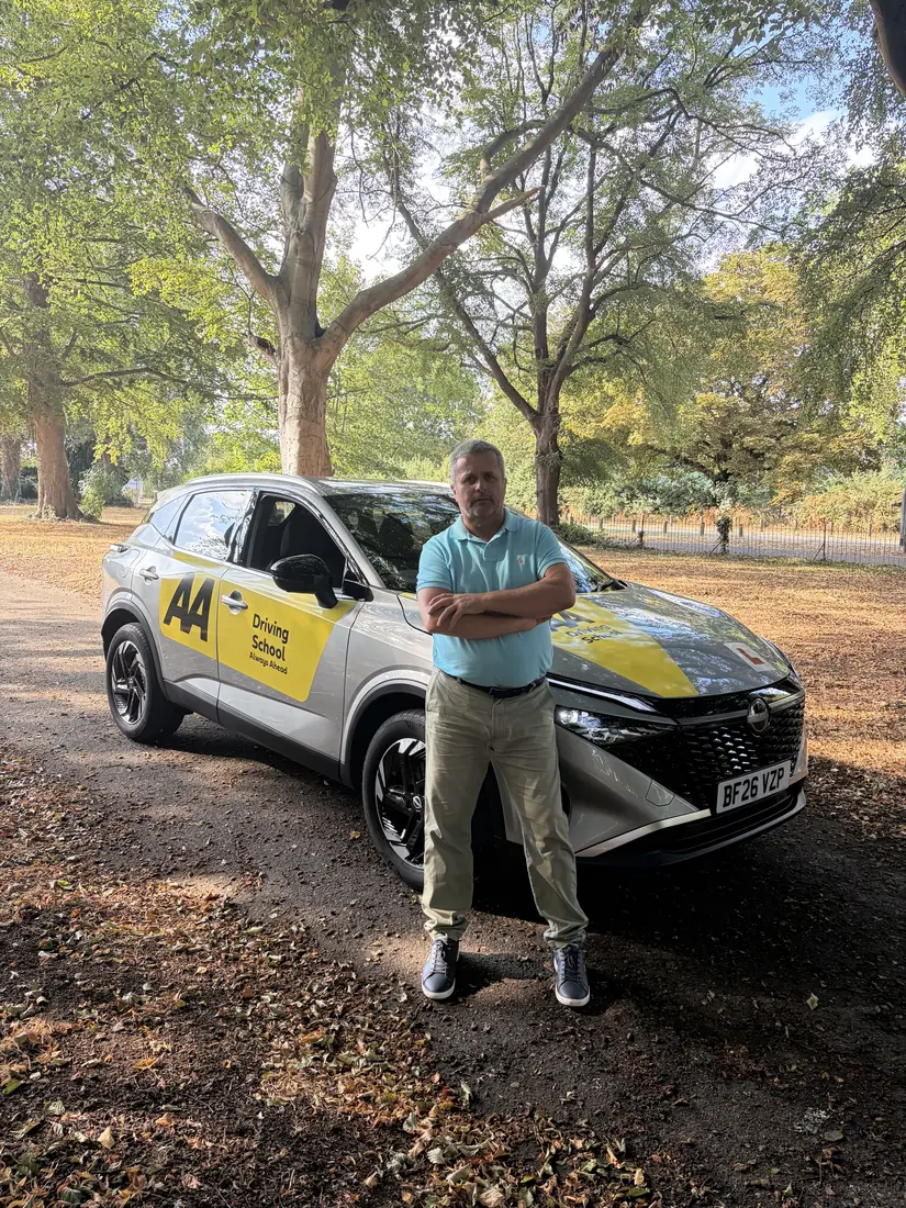 Maurizio, DVSA-approved driving instructor, beside his dual-control driving-school car